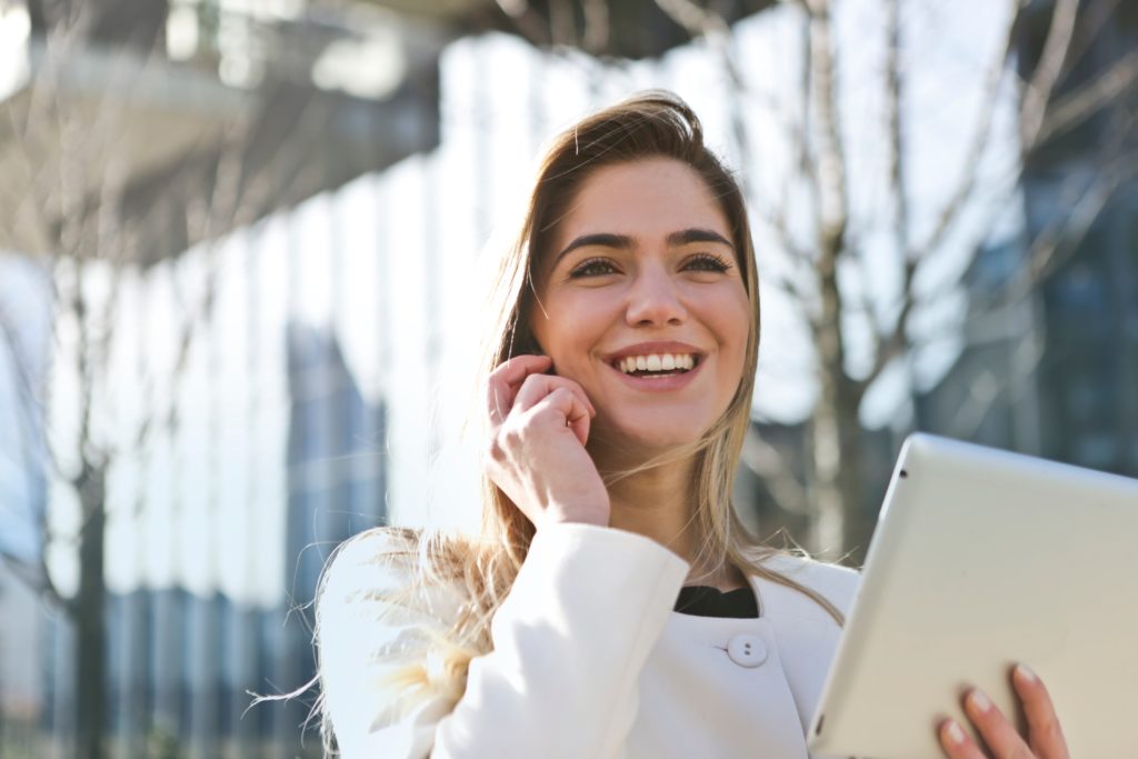 Professional speaking on the phone while holding a tablet