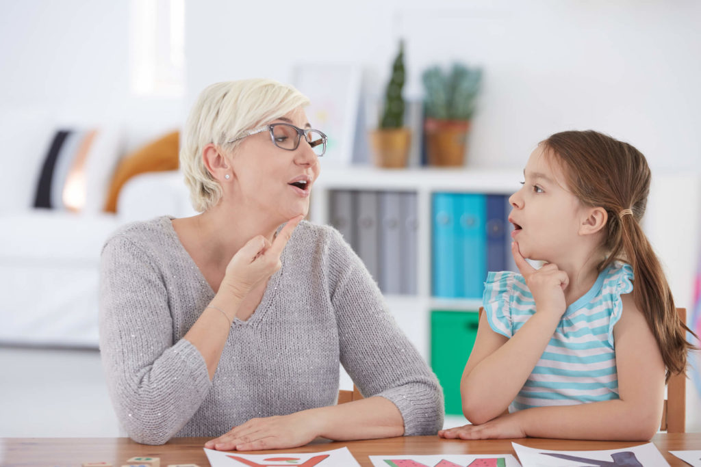 Speech-language professional working with a child